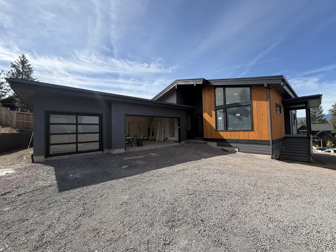 Completed modern home with garage and wood accent entry