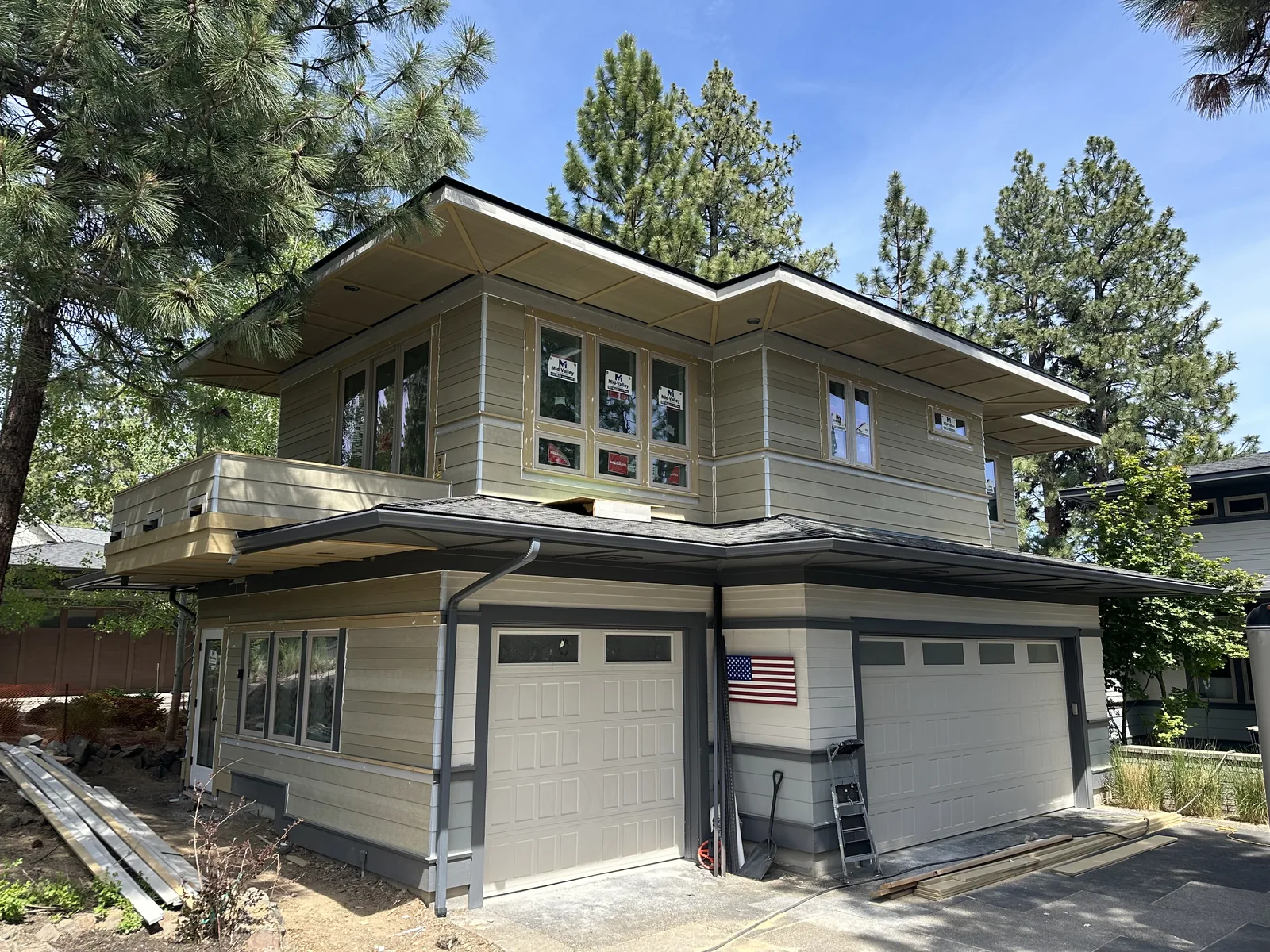Completed two-story home with dark lap siding, crisp trim and fresh gutters installed by RGC